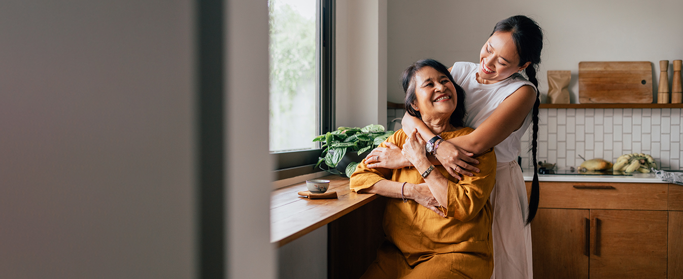 younger woman hugging older woman