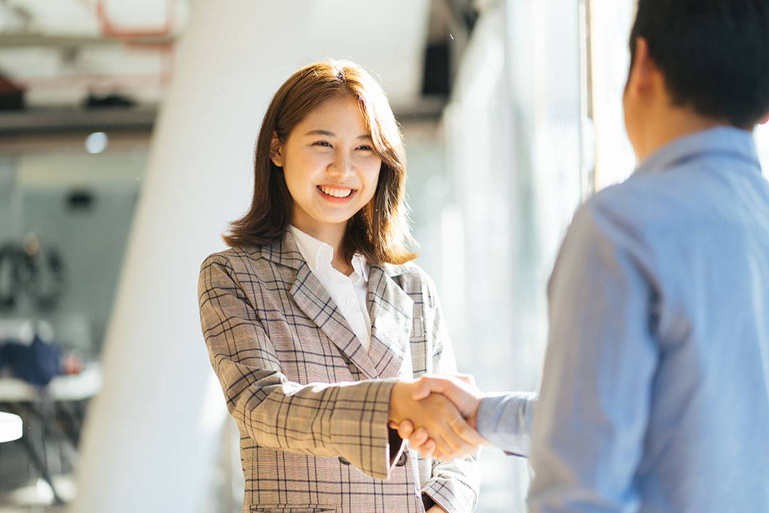 man and women shaking hands