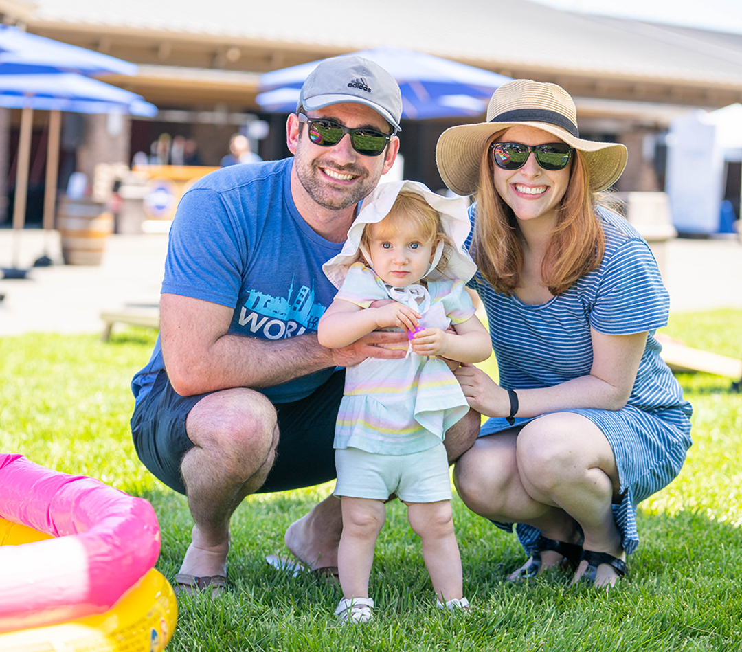 family smiling on grass